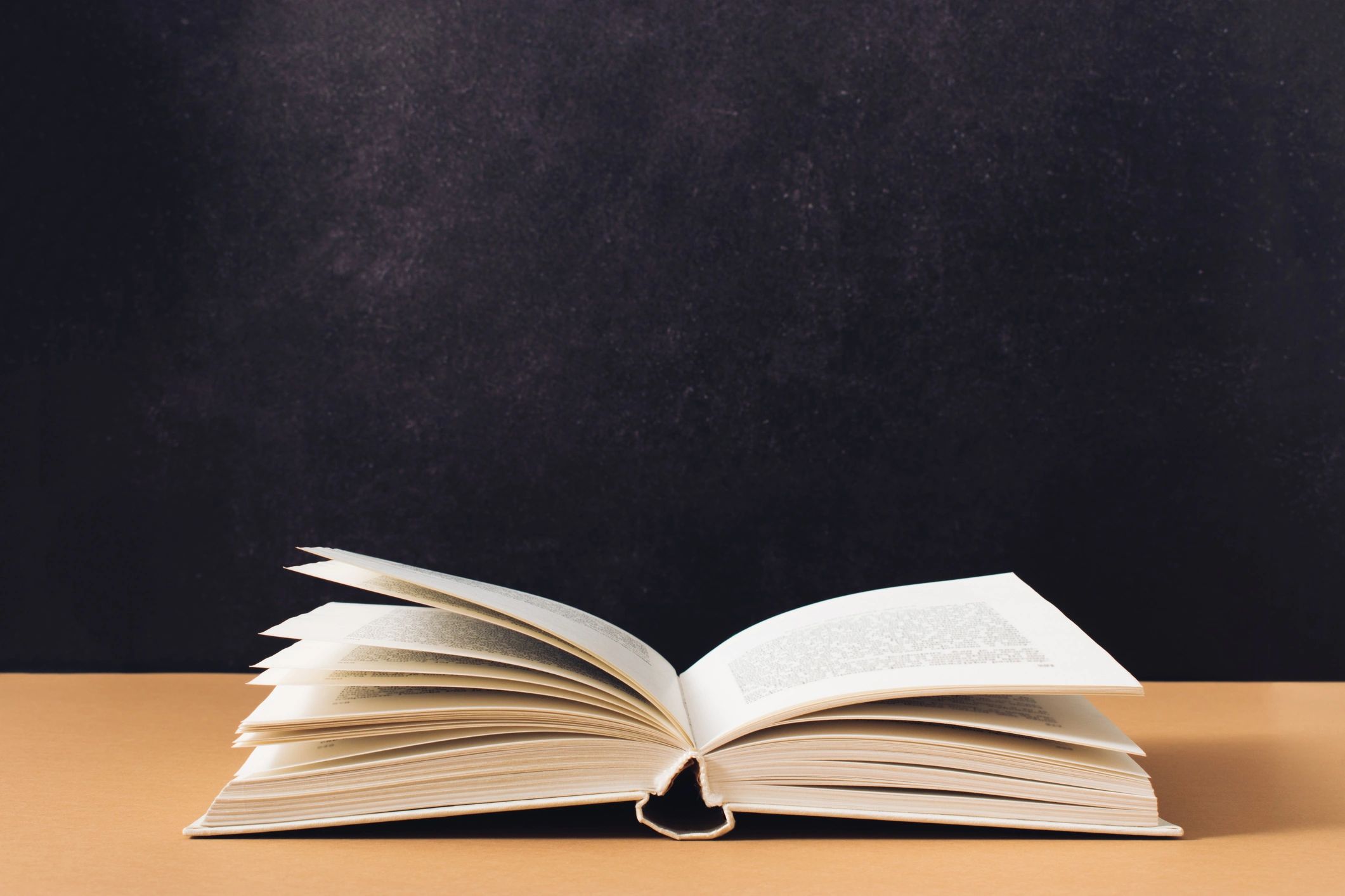 Open book on dark textured background