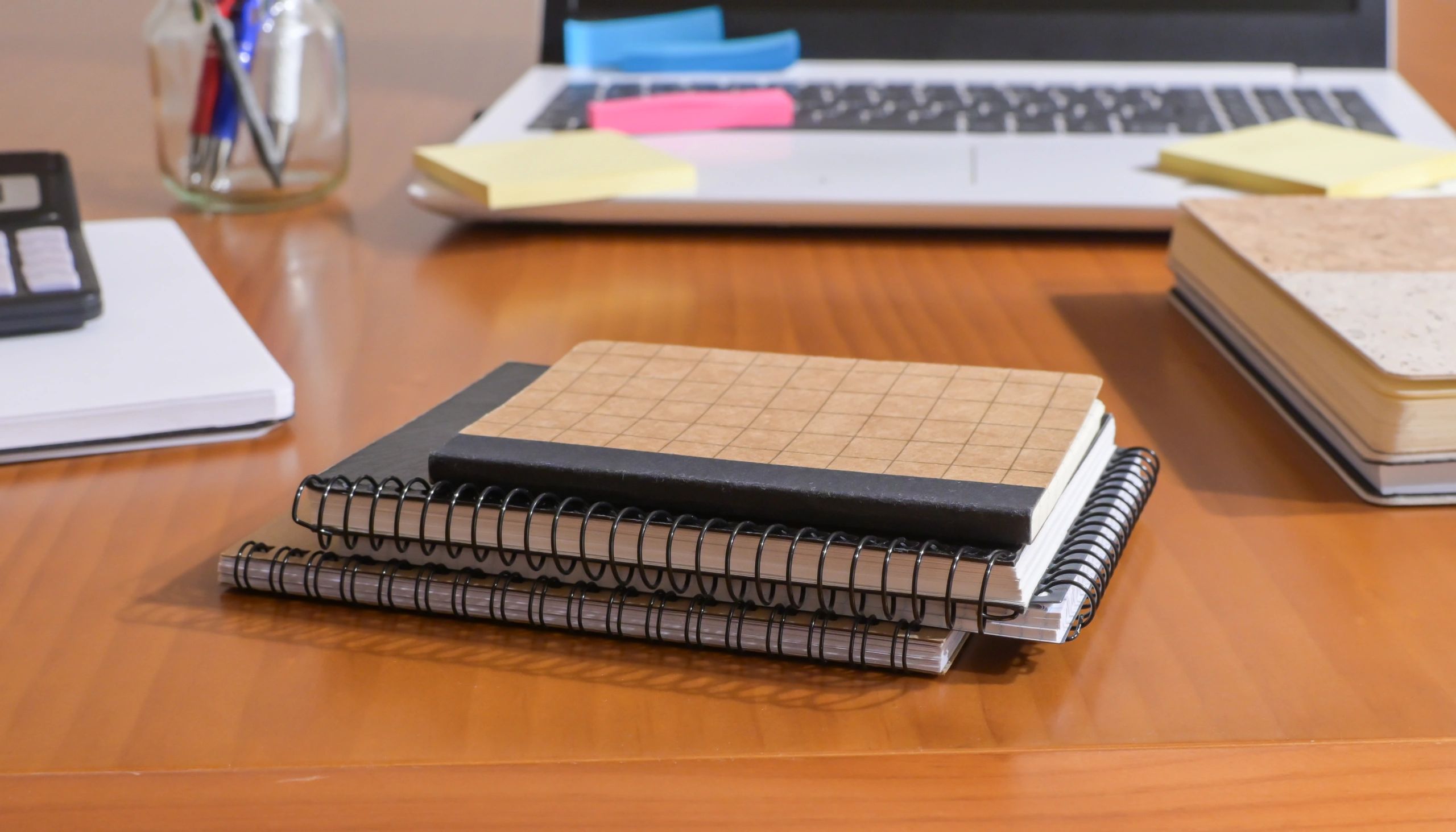 Study desk with notebooks and laptop for learning resources